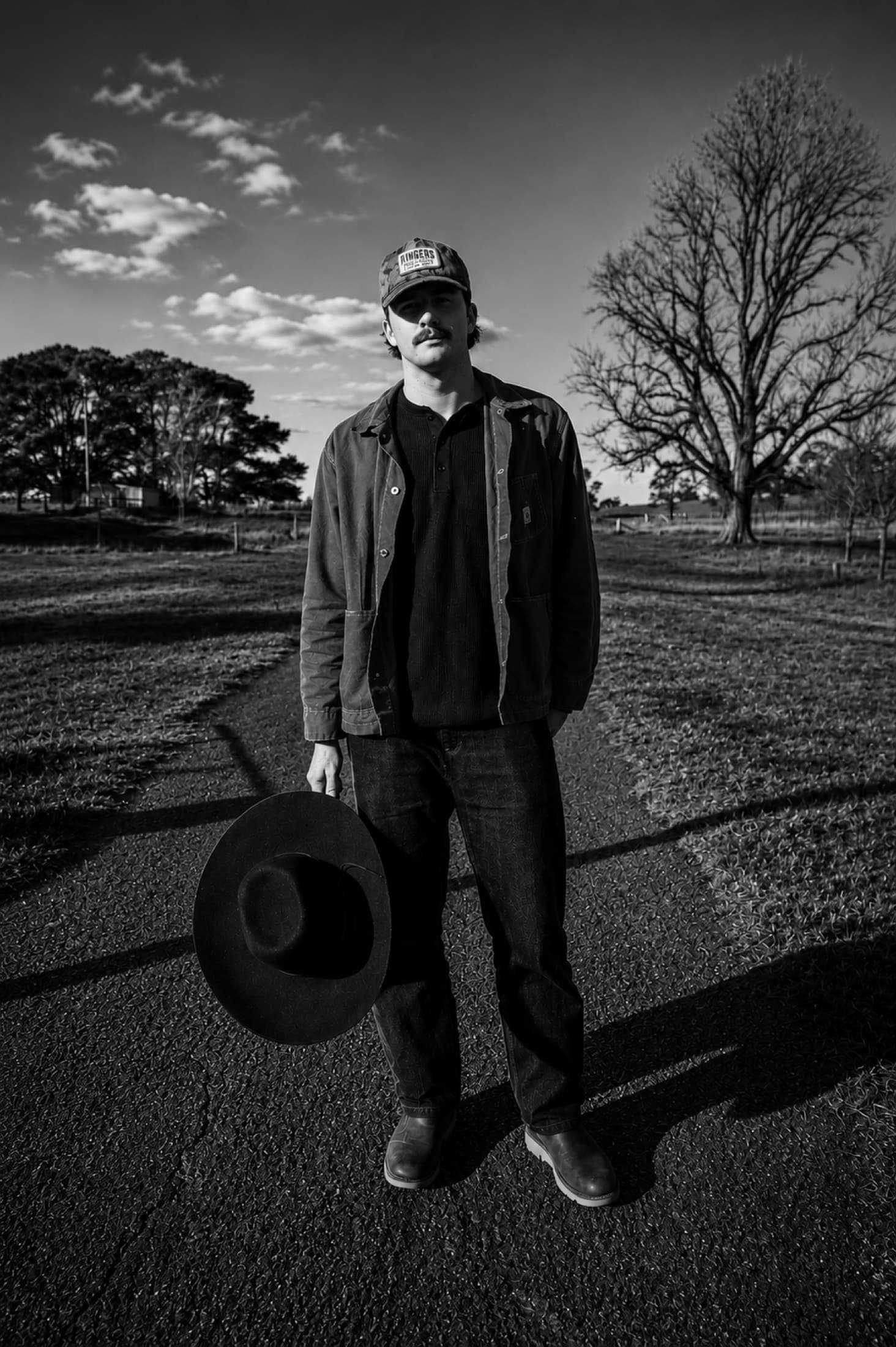 Kai Rennie on a country road, black and white