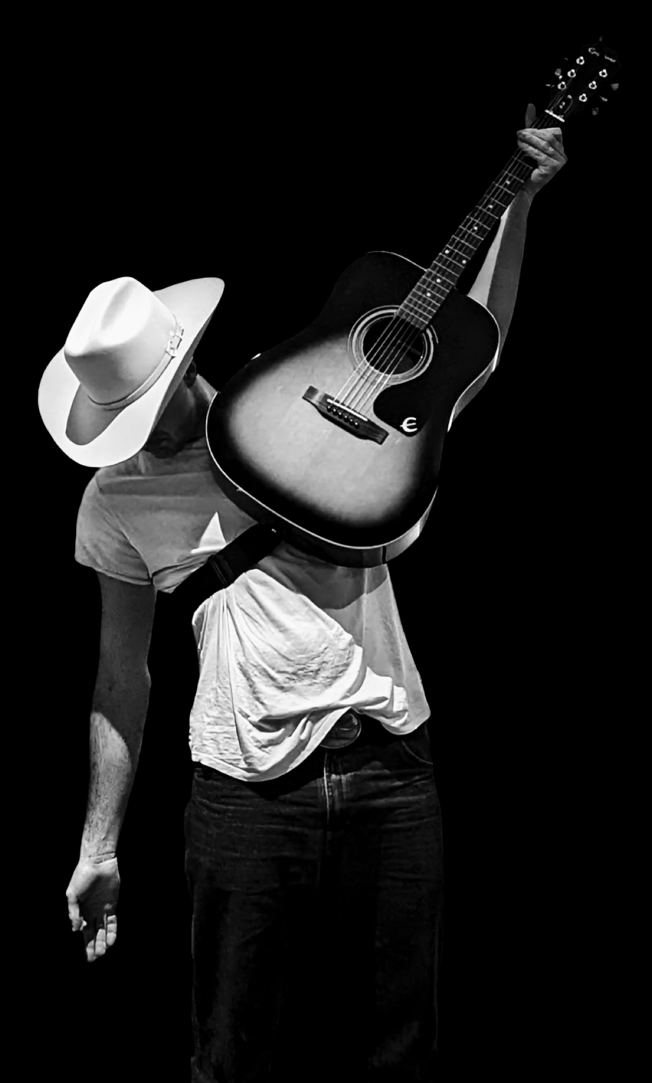 Kai Rennie raising his guitar